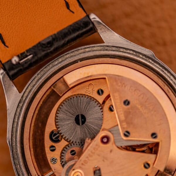 Omega caliber 351 bumper automatic, macro detail of copper-toned bridges and balance wheel