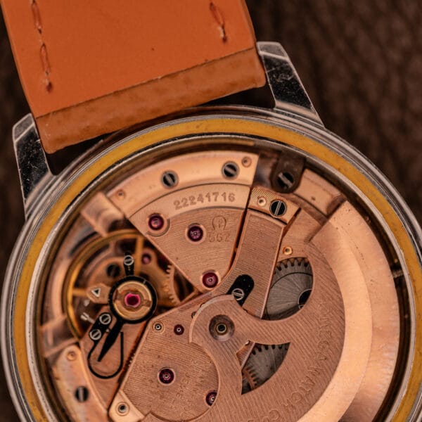 Omega caliber 562 movement macro showing the 562 caliber stamp, jewels and full-rotor automatic architecture