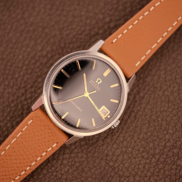 Omega Seamaster 166.002 top-down close-up on tan grained leather strap with OTTUHR-signed buckle setup