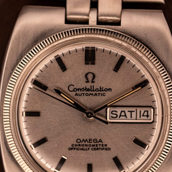 Omega Constellation 168.045 factory silver dial close-up with applied black baton markers and fluted bezel