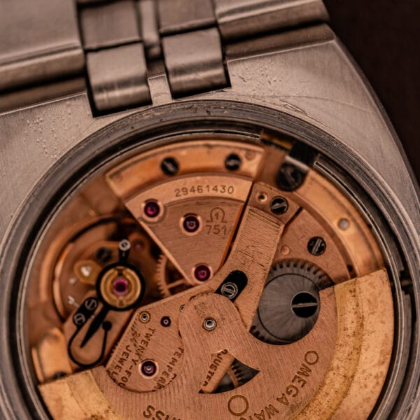 Omega caliber 751 movement detail showing TWENTY FOUR 24 JEWELS FIVE ADJUSTMENTS rotor stamping