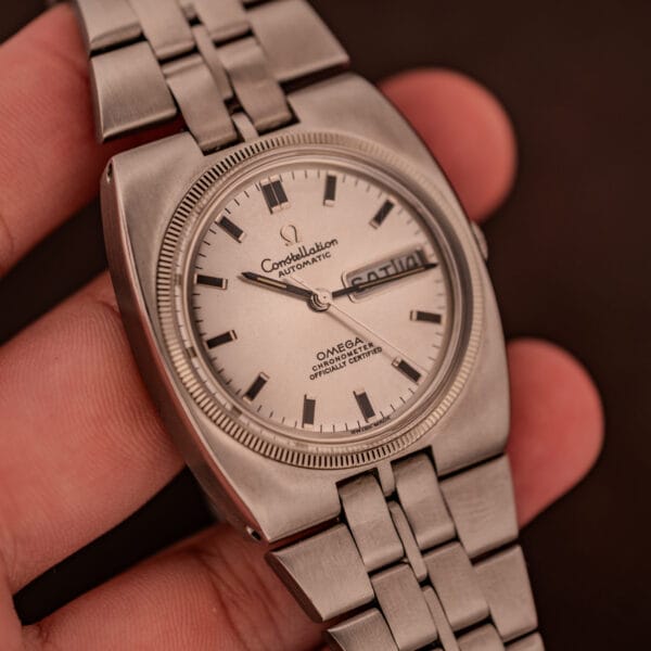 Omega Constellation 168.045 in hand showing fluted bezel and integrated bracelet flow