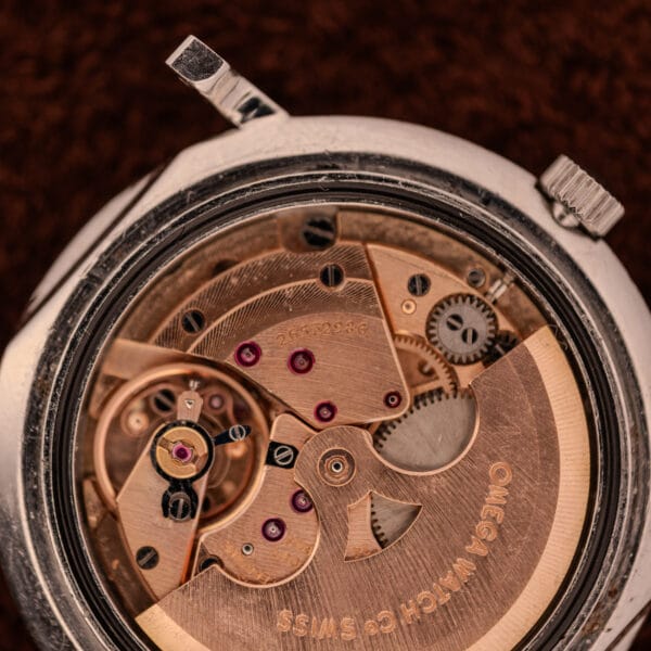Omega caliber 712 ultra-thin automatic chronometer movement closeup with copper-toned bridges and serial 24552986