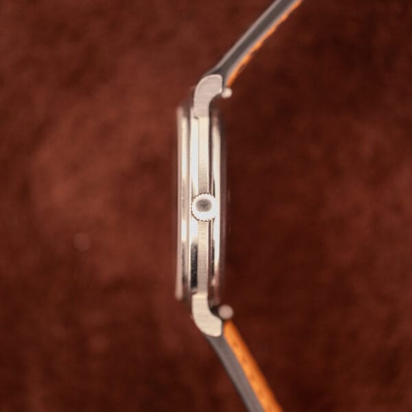 Omega Constellation 157.0001 side profile showing ultra-thin steel case and signed crown