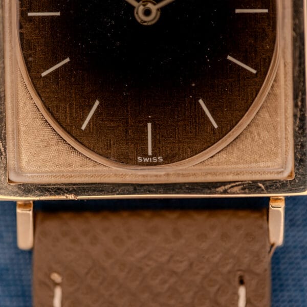 Florentine cross-hatched 10k gold filled case frame around the circular Leopard sub-dial of the Longines Tank ref 3217-428, SWISS designation at six