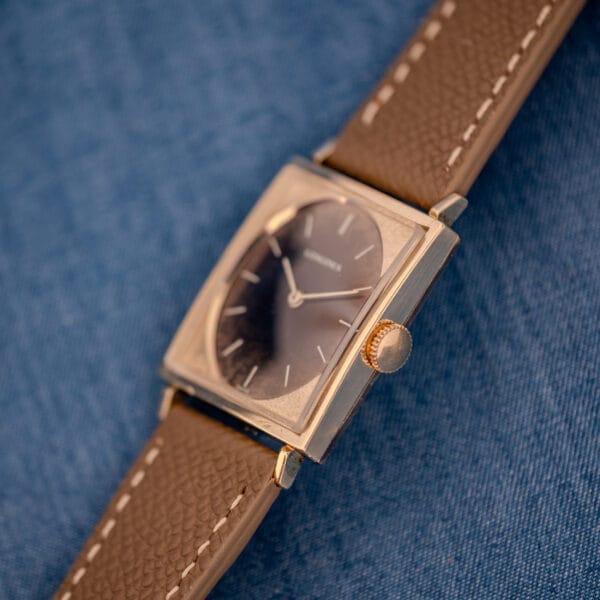 Angled view of the Longines Tank 3217-428 showing the case depth, signed crown, and chocolate Leopard dial of this vintage Longines Tank watch