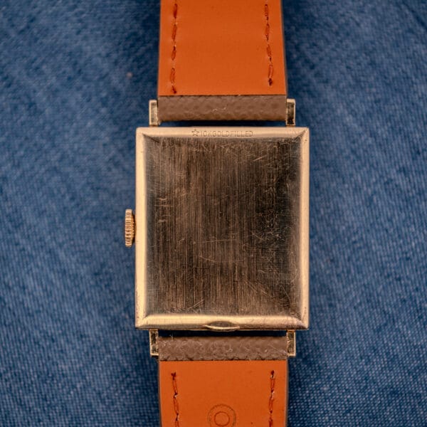 Outer caseback of the Longines Tank 3217-428 stamped with the star symbol and 10K GOLD FILLED designation along the top edge