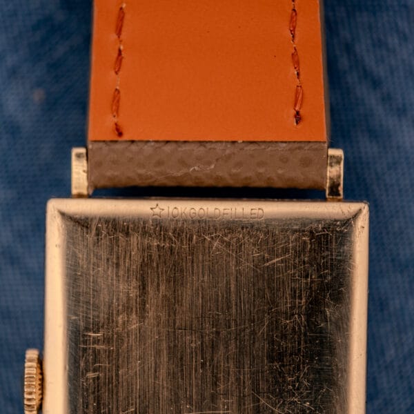 Close-up of the 10K GOLD FILLED star stamping on the outer caseback of the vintage Longines Tank 3217-428