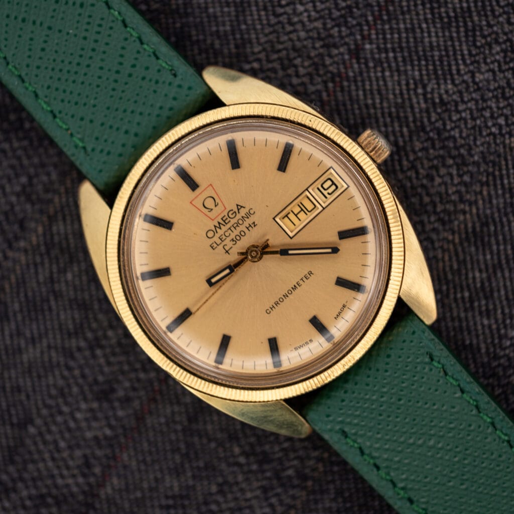Omega Electronic F-300 Hz Chronometer ref. 1980045 with sunburst champagne day-date dial on a pine green saffiano leather strap