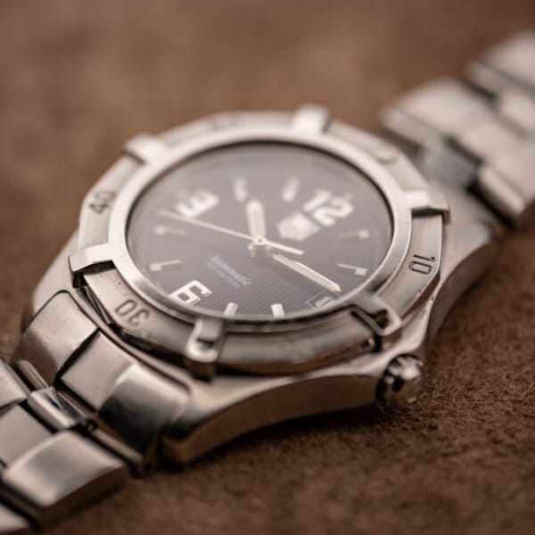 TAG Heuer 2000 Series WN2111 dial macro showing fine checkered waffle texture and SWISS MADE designation