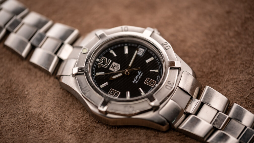 Vintage TAG Heuer 2000 Series Professional Exclusive automatic with black waffle dial, applied numerals, and steel bracelet