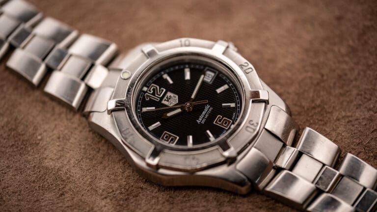 Vintage TAG Heuer 2000 Series Professional Exclusive automatic with black waffle dial, applied numerals, and steel bracelet