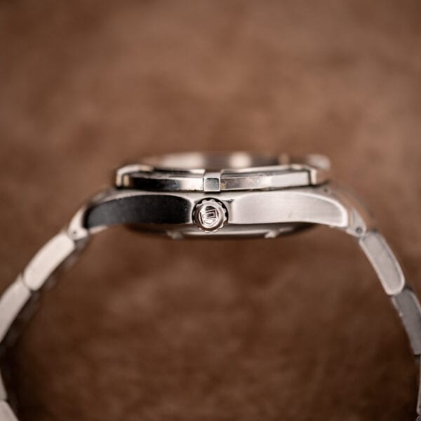 TAG Heuer WN2111 case side profile showing screw-down crown with TAG shield logo