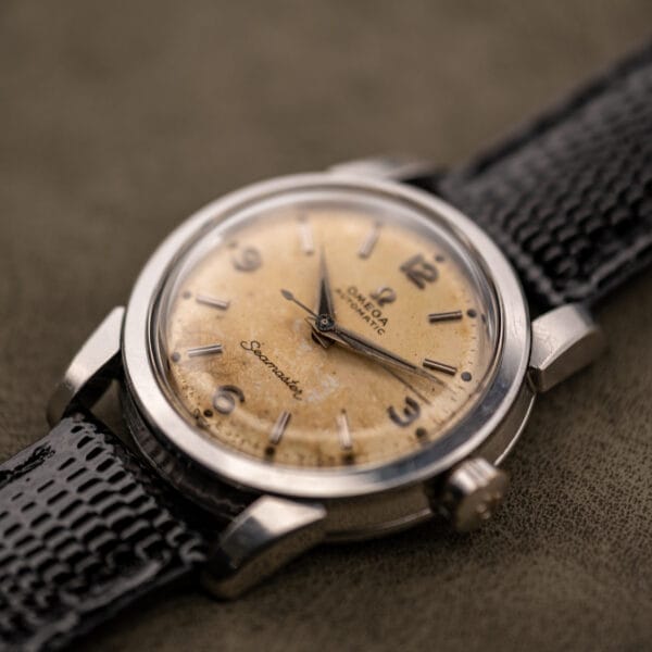 Omega Seamaster 2828 angled three-quarter view showing dial patina and lug shape