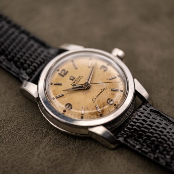 Omega Seamaster 2828 dial angle showing cushion case faceted lugs and tropical patina
