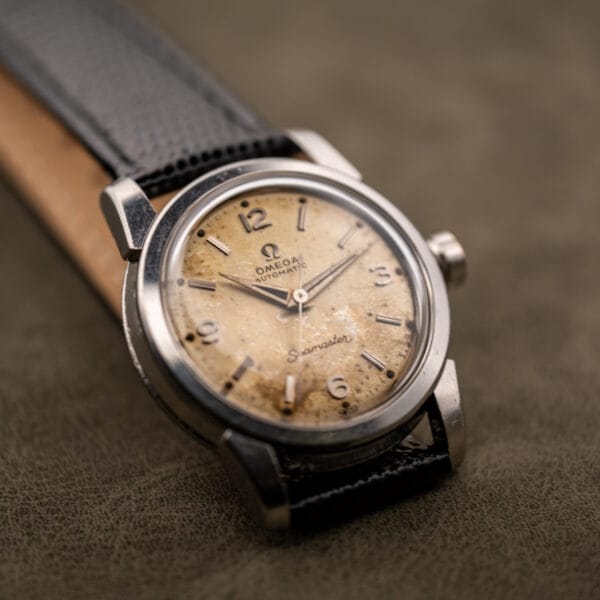 Omega Seamaster 2828 three-quarter angle on black lizard strap, factory tropical dial
