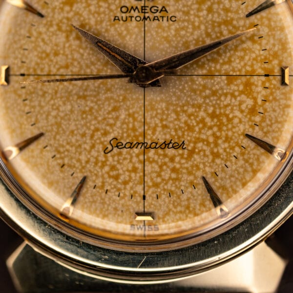 Omega Seamaster 14363-3 lower dial macro with cursive Seamaster script and SWISS print over tropical patina