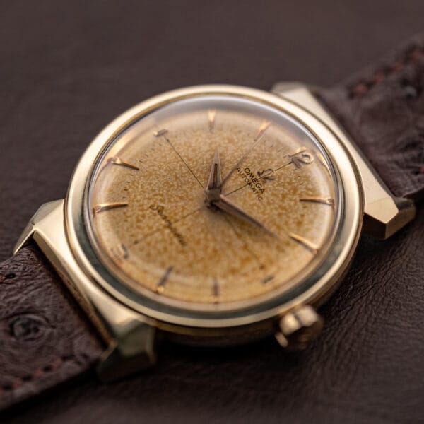 Omega Seamaster 14363-3 angled three-quarter view of gold-capped case and chocolate-cream tropical dial