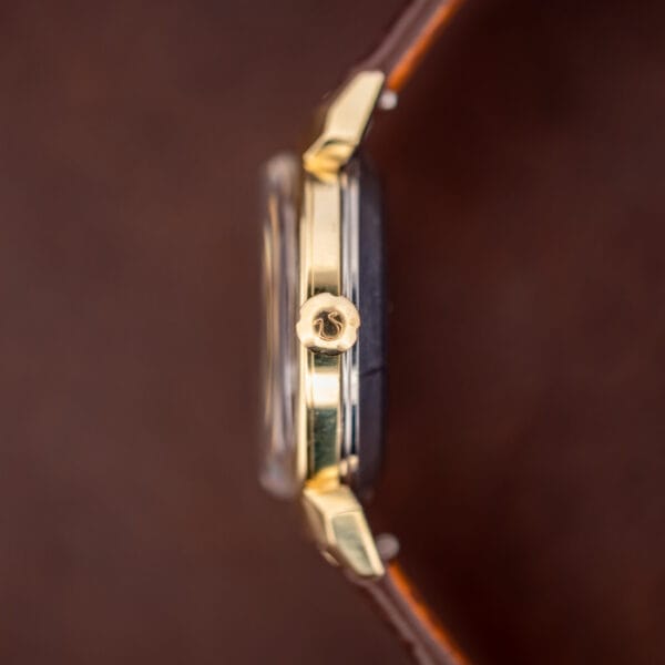 Omega Seamaster 14363-3 crown-side case profile macro showing Omega-signed crown and steel mid-case band