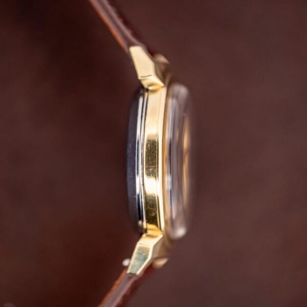 Omega Seamaster 14363-3 opposite case profile showing gold-capped lugs over stainless steel core