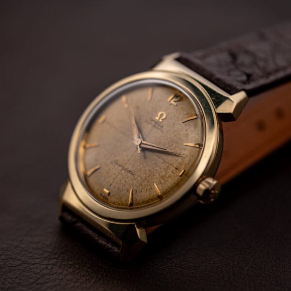 Omega Seamaster 14363-3 hero three-quarter shot of gold-capped scarab case and tropical dial