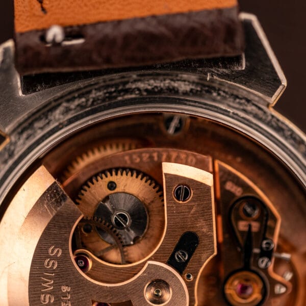 Omega caliber 500 movement macro showing copper finish, Omega-signed rotor, and serial 15217750