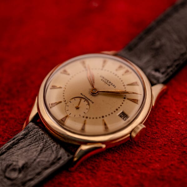 Universal Geneve Automatic Bumper 138C three-quarter view with roulette date and champagne dial