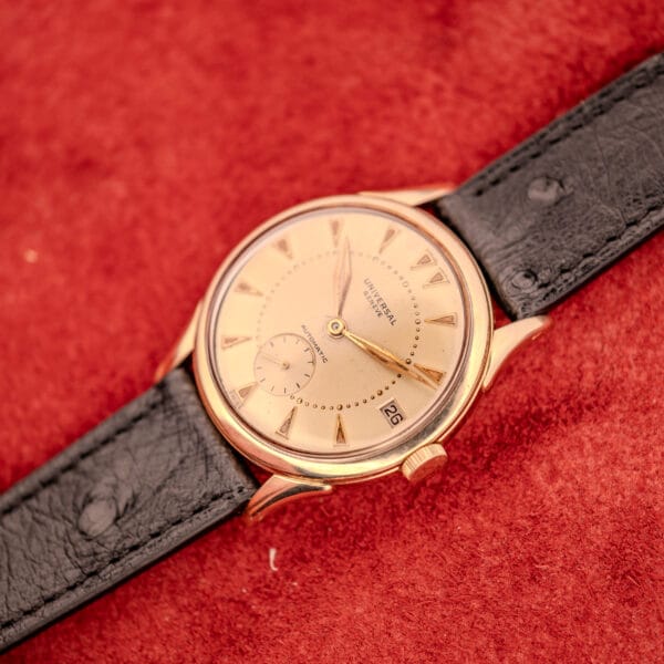 Universal Geneve Automatic Bumper 138C in-hand view showing champagne dial and gold-filled case