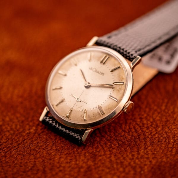 LeCoultre 3022 dress watch angled on leather, white gold filled case and faceted lugs with honey-aged dial