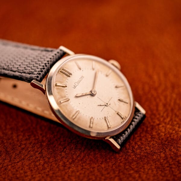 Vintage LeCoultre 3022 three-quarter view on caramel leather showing 10k white gold filled case profile