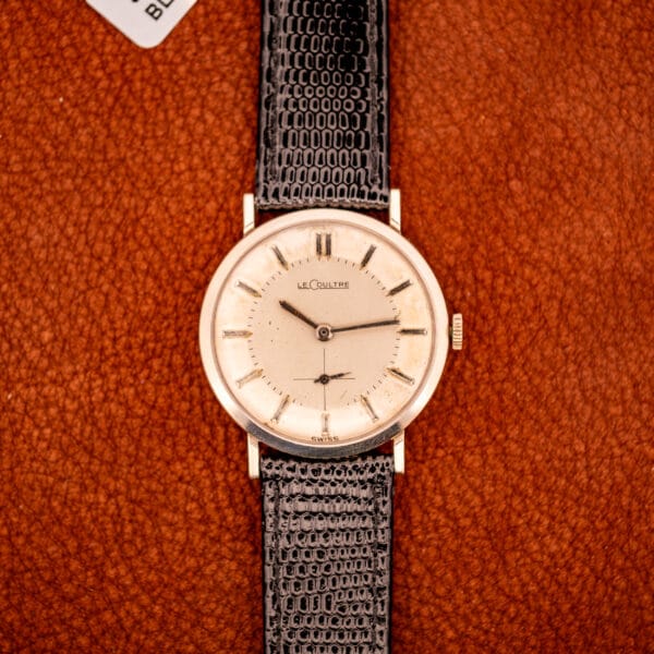 LeCoultre 3022 vertical product shot on caramel leather, honey patina dial signed LeCoultre with applied baton markers