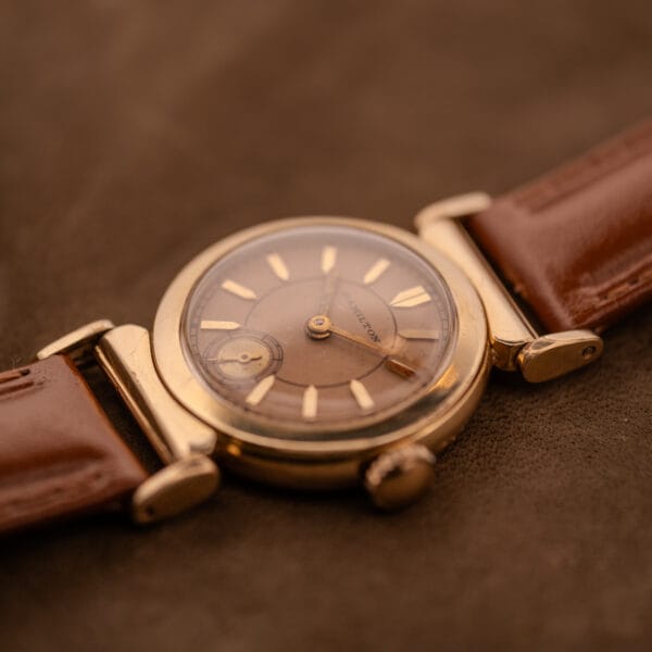 1935 Hamilton Prescott Hamilton 14k gold filled vintage watch on cognac strap in raking light