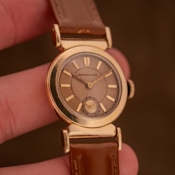 1935 Hamilton Prescott in hand showing 14k gold filled scarab case and salmon dial