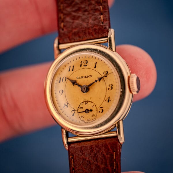 1936 Hamilton Randolph angled in hand showing dial, signed crown, and 10k gold filled case from above