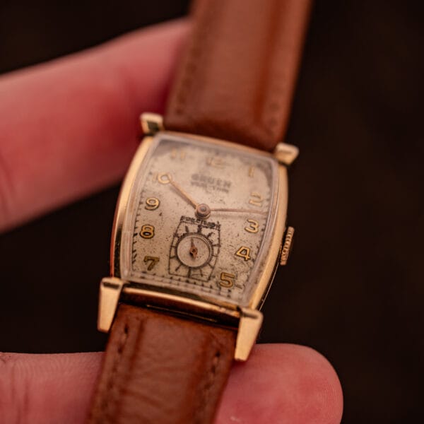 Gruen Precision Veri-Thin tank watch worn in hand, factory silver dial and scrolled gold filled lugs