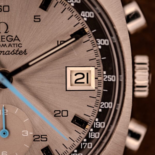 Omega Seamaster 176.007 dial detail with polished date aperture at 3 and black tachymetre scale graduated to 500