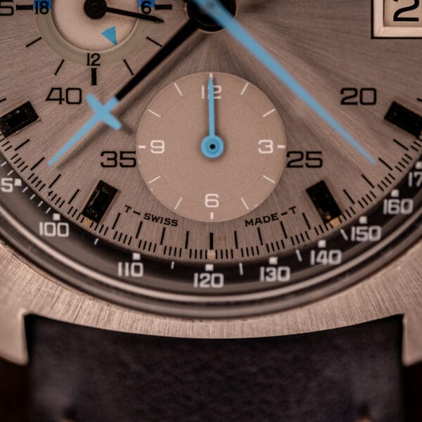Omega 176.007 lower dial showing crosshair running seconds sub-dial at 6 and T SWISS MADE T tritium marking