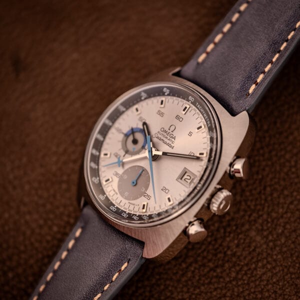 Omega 176.007 Blue Jedi three-quarter angle from crown side showing pump pushers and signed Omega crown