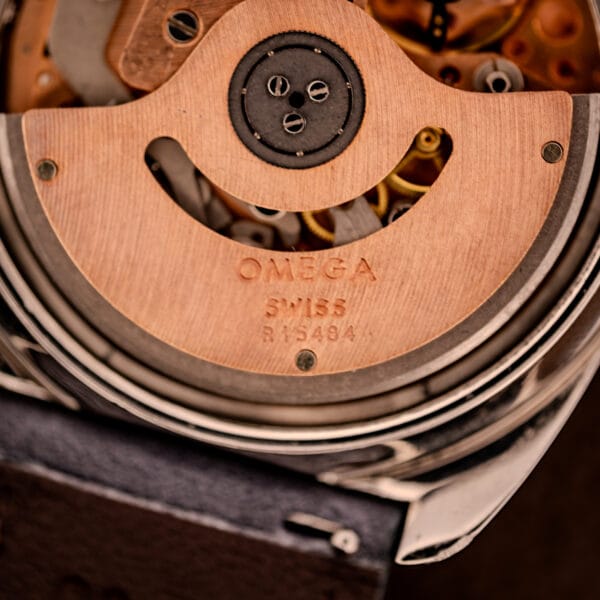 Omega caliber 1040 rotor macro stamped OMEGA SWISS R 15484 with copper-toned bridges showing factory finishing