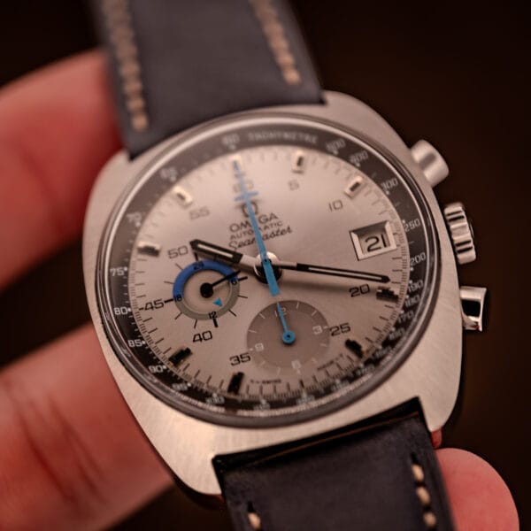 Omega Seamaster 176.007 in-hand angled shot highlighting the sky-blue chronograph seconds hand and 24-hour totalizer
