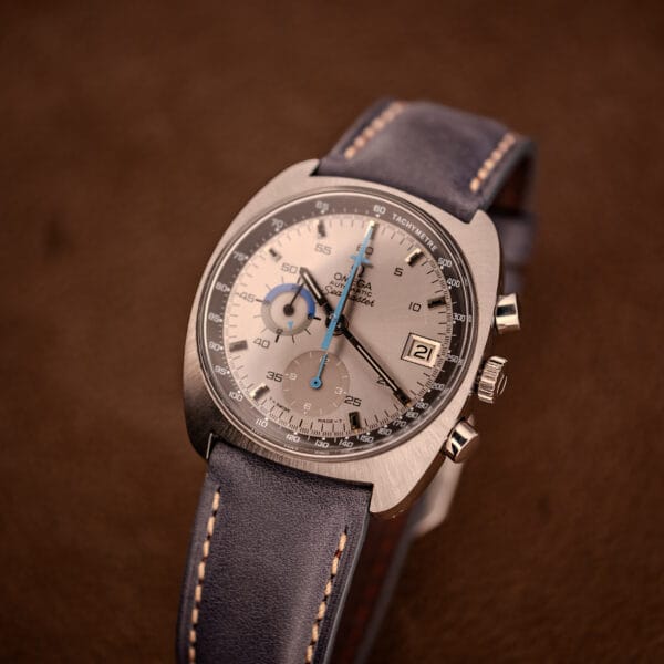 Omega Seamaster 176.007 Blue Jedi lifestyle three-quarter view on navy leather strap with cream contrast stitching