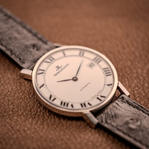 Jaeger LeCoultre Ultra Thin wider angle on tan leather, full black Roman numeral chapter ring framing the white dial.