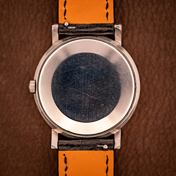 Jaeger LeCoultre Ref. 5003.42 plain stainless steel outer caseback with honest hairlines and even patina across the polished surface.
