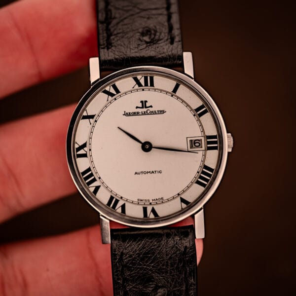 Jaeger LeCoultre Ultra Thin held in hand showing dial face, 34.5mm steel case proportions, black ostrich leather strap.