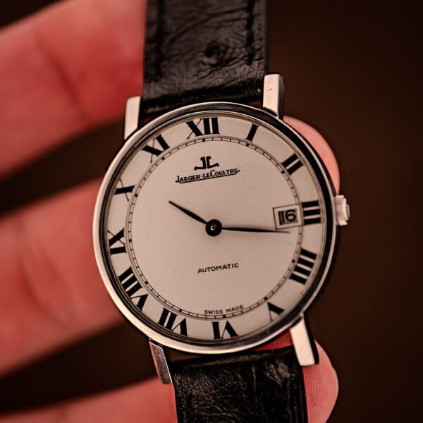 Jaeger LeCoultre Ultra Thin Ref. 5003.42 wrist-perspective on leather, thin black baton hands sweeping the white Roman numeral dial.