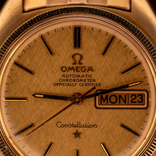 Omega Constellation 168.029 linen-finish gold dial with OMEGA logo, AUTOMATIC CHRONOMETER OFFICIALLY CERTIFIED text and day-date window