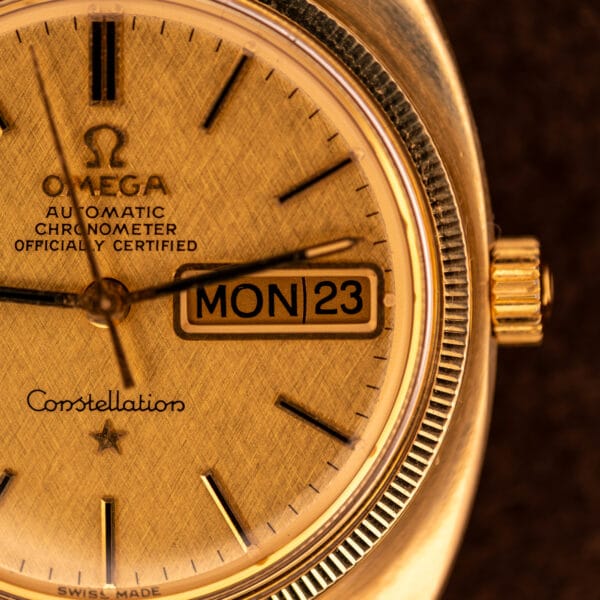 Omega Constellation 168.029 dial close-up showing fluted gold bezel, signed crown, day-date complication and Constellation script with star