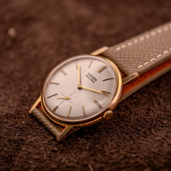 Gruen Precision 510 angled close-up of cream dial, gold crown, and sub-seconds register at six