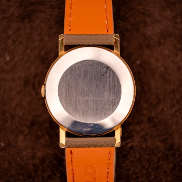 Gruen Precision 510 plain stainless steel snap-on caseback showing honest light service marks from decades of wear