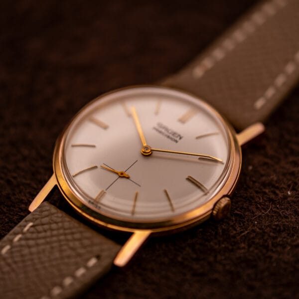Gruen Precision 510 Doctor No Bond watch three-quarter angle showing gold-plated round case and tapered lugs